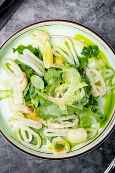 salad with arugula, parsley, lime and squid rings