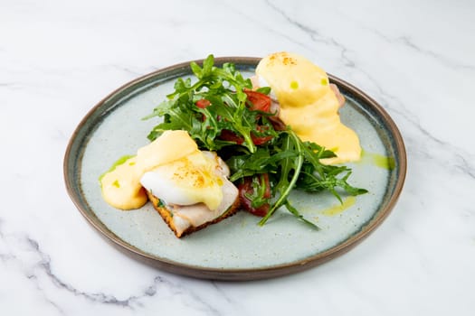 breakfast of arugula and tomato, toast with cheese and poached egg