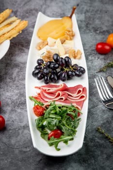 assorted fruits, grape nuts, bacon and arugula