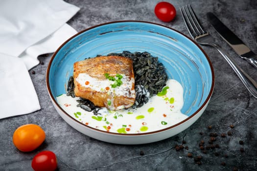 black beans with big fish steak, green onions and cream sauce