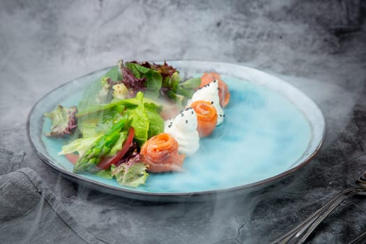 salad of leaves of different types of lettuce and fish rolls