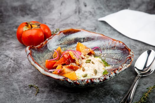 dish of baked persimmons, colored peppers, rice and seeds