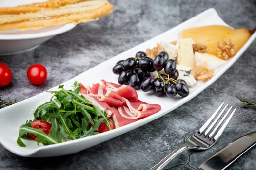 assorted fruits, grape nuts, bacon and arugula