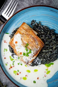 black beans with big fish steak, green onions and cream sauce