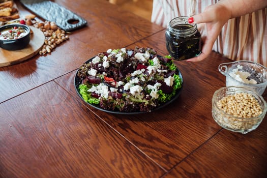 Woman cook at home in kitchen preparing salad for eating