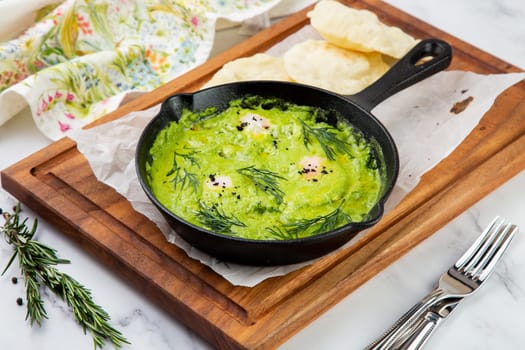 broccoli cream soup with herbs, cheese and tortillas in a frying pan