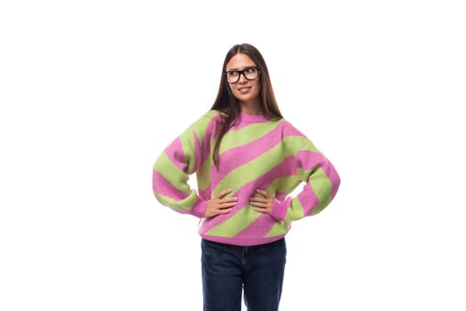well-groomed pleasant smiling young european brunette woman dressed in a casual striped pink-green pullover.
