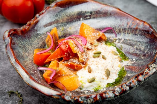 dish of baked persimmons, colored peppers, rice and seeds