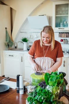 Woman cook at home in kitchen preparing salad for eating