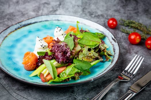 salad of leaves of different types of lettuce and fish rolls