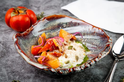 dish of baked persimmons, colored peppers, rice and seeds