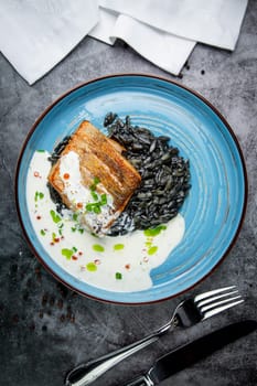 black beans with big fish steak, green onions and cream sauce