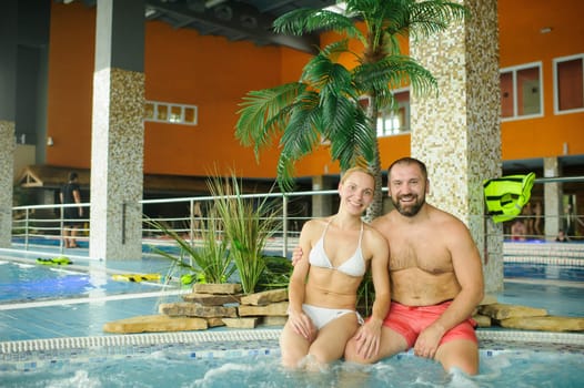 Portrait of a couple enjoying a vacation in the pool.