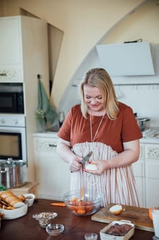 Female in kitchen cooking food from vegetables