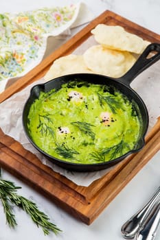 broccoli cream soup with herbs, cheese and tortillas in a frying pan