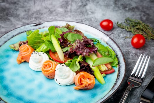 salad of leaves of different types of lettuce and fish rolls