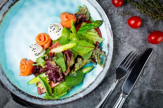 salad of leaves of different types of lettuce and fish rolls