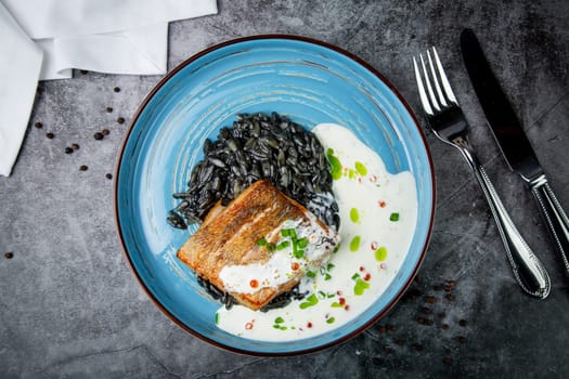 black beans with big fish steak, green onions and cream sauce