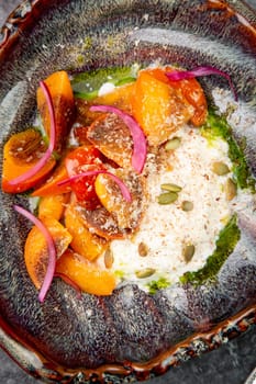 dish of baked persimmons, colored peppers, rice and seeds