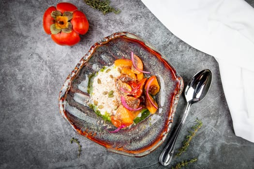 dish of baked persimmons, colored peppers, rice and seeds