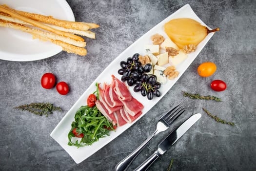 assorted fruits, grape nuts, bacon and arugula