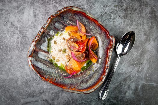 dish of baked persimmons, colored peppers, rice and seeds