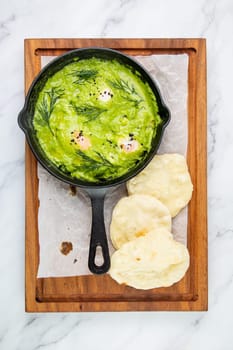 broccoli cream soup with herbs, cheese and tortillas in a frying pan