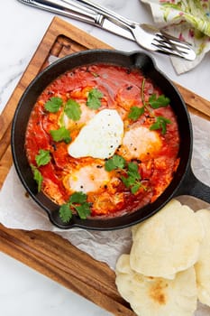 beetroot borscht with sour cream and parsley in a frying pan