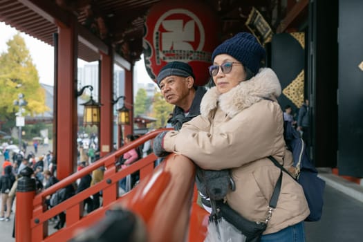 Senior couple admiring the temple filled with wonder at the beauty of architecture during their active retirement.