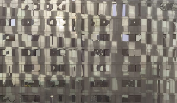 Liverpool, UK - Oct 07, 2023 - Sky reflection on Glass wall of Modern building with Repeating structure. Exterior architecture of building, Space for text, Selective focus.