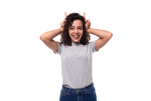 adorable slim curly brunette promoter woman with glasses dressed in gray basic t-shirt with logo print mockup.