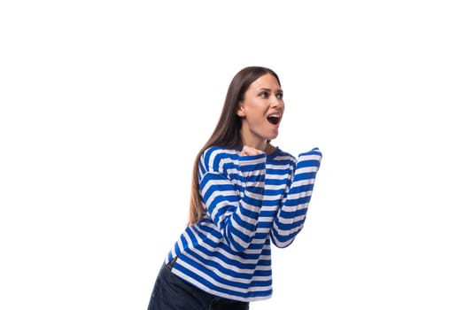 young cute slender brunette lady with straight hair is dressed in a blue striped sailor jacket.