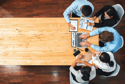 Panorama top view diverse group of business analyst team analyzing financial data report paper on meeting table. Chart and graph dashboard by business intelligence analysis. Meticulous