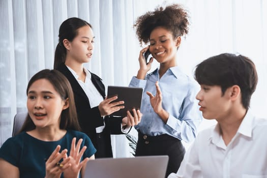 Happy diverse business people work together, discussing in corporate office. Professional and diversity teamwork discuss business plan on desk with laptop. Modern multicultural office worker. Concord