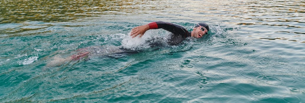 A professional triathlete trains with unwavering dedication for an upcoming competition at a lake, emanating a sense of athleticism and profound commitment to excellence