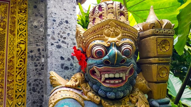 figure guarding the entrance to a Hindu temple, statue of sacred temple in Bali, balinese temple guardian, balinese gnome, Traditional Balinese statues or called Arca made of stone carvings in the form of gods, people or demons. Balinese sculpture in temple.