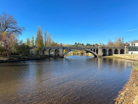 Hiker's point of view along the Tamega river city park in Chaves, Portugal.