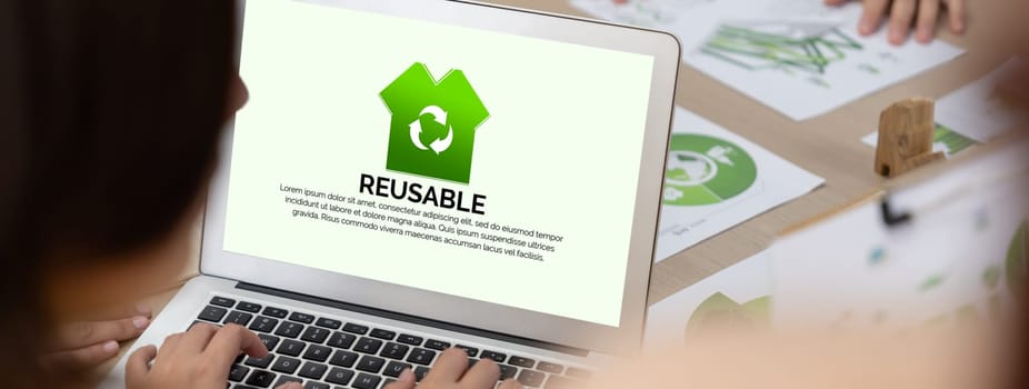 Reusable sign displayed on green business laptop while business team presenting green design to customer. ESG environment social governance and Eco conservative concept. Closeup. Delineation