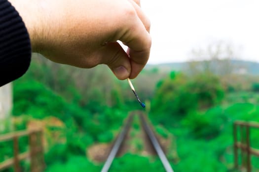 Matches on a rails railroad tracks background, fire on railways concept