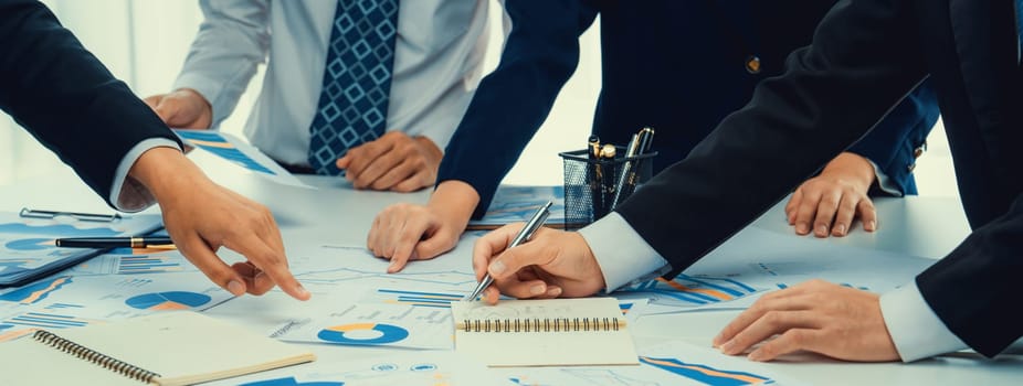 Business people in group meeting in formal attire share idea discussing report for company profit in creative workspace for start up business shot in close up view on group meeting table . Oratory .