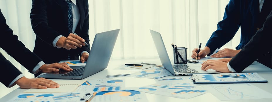 Business people in group meeting in formal attire share idea discussing report for company profit in creative workspace for start up business shot in close up view on group meeting table . Oratory .