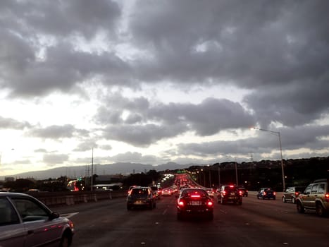 Honolulu - November 18, 2014: A view of the H-1 highway at dusk with cars and street lights.