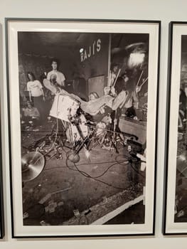 Seattle - May 16, 2019:  American grunge rock band Nirvana performing live at Raji's photo displayed at the Seattle Art Museum. The photo shows lead singer and guitarist Kurt Cobain, bassist Krist Novoselic, and drummer Dave Grohl on stage.  The photo is framed by a white mat and a black metal frame.