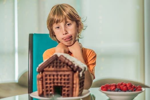 Immerse in festive delight as a boy crafts boy crafting an unconventional gingerbread house, infusing Christmas with unique creativity and festive cheer. A sweet scene of seasonal bonding and culinary fun.