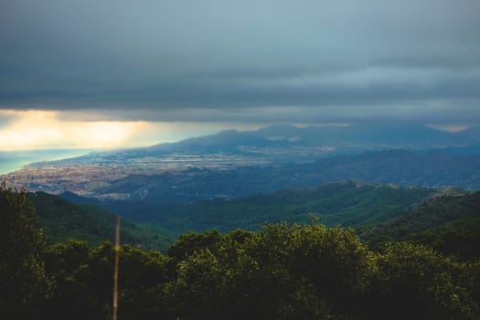 Heavy rain clouds on background of mountains and forest, Spain, Granada