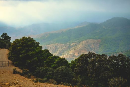 Heavy rain clouds on background of mountains and forest, Spain, Granada