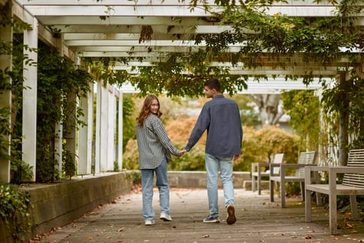 Young Cute Female Hugs Boyfriend. In Autumn Outdoor. Lovers Walking in Park. Attractive Funny Couple. Lovestory in Forest. Man and Woman. Cute Lovers in the Park. Family Concept. Happy Couple.