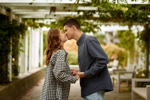 Young Cute Female Hugs Boyfriend. In Autumn Outdoor. Lovers Walking in Park. Attractive Funny Couple. Lovestory in Forest. Man and Woman. Cute Lovers in the Park. Family Concept. Happy Couple.