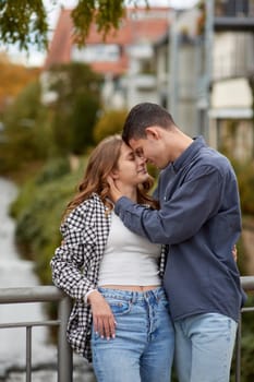 Young Cute Female Hugs Boyfriend. In Autumn Outdoor. Lovers Walking in Park. Attractive Funny Couple. Lovestory in Forest. Man and Woman. Cute Lovers in the Park. Family Concept. Happy Couple.