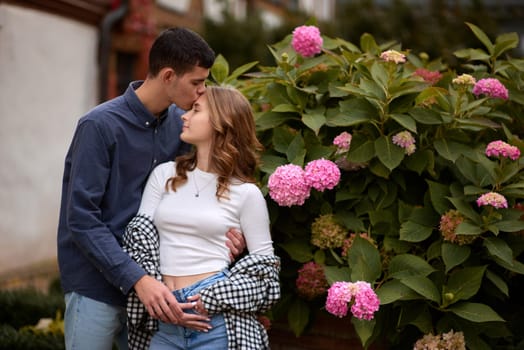 Young Cute Female Hugs Boyfriend. In Autumn Outdoor. Lovers Walking in Park. Attractive Funny Couple. Lovestory in Forest. Man and Woman. Cute Lovers in the Park. Family Concept. Happy Couple.